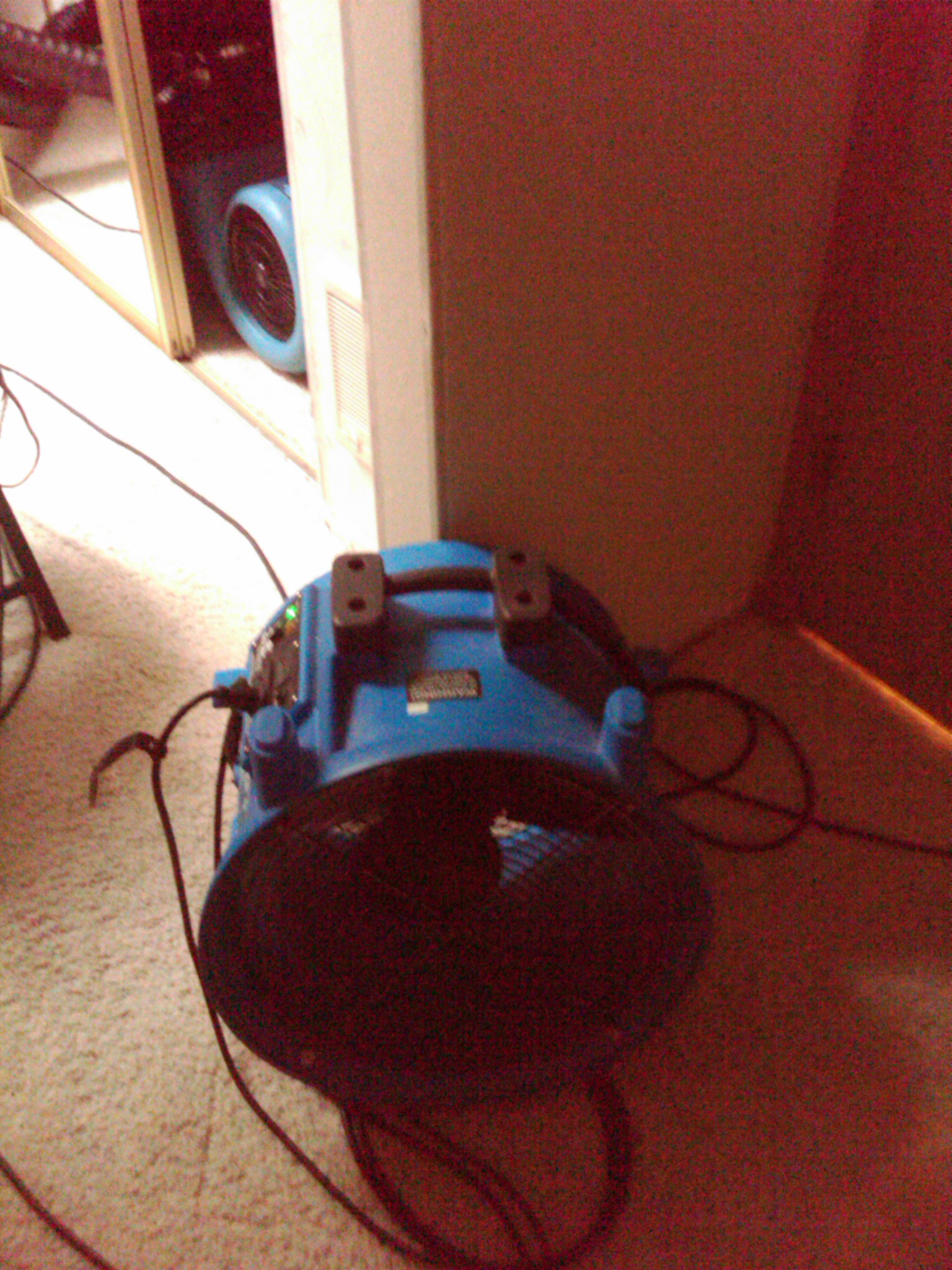 Drying a wet wall after a water damage in Vancouver WA with an axial fan.