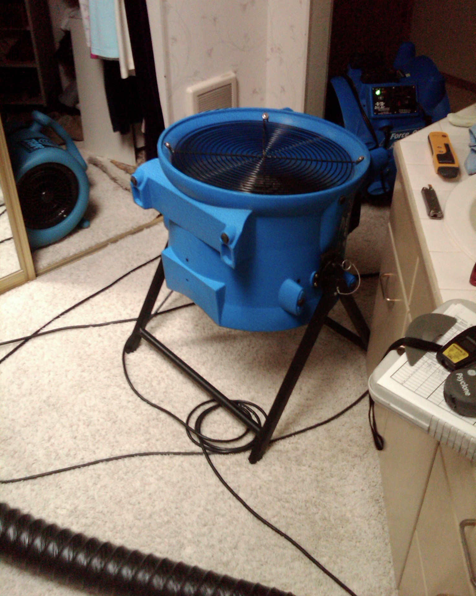 A blue axial fan drying carpet in a bathroom in 3111 Se Balboa Dr, Vancouver WA 98683