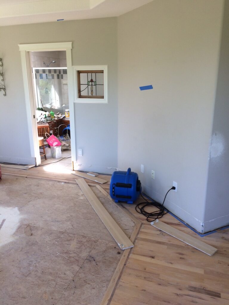 A family room at 31213 NE 69th St Camas, WA 98607 with carpet removed and exposed subfloor because of a water damage restoration project