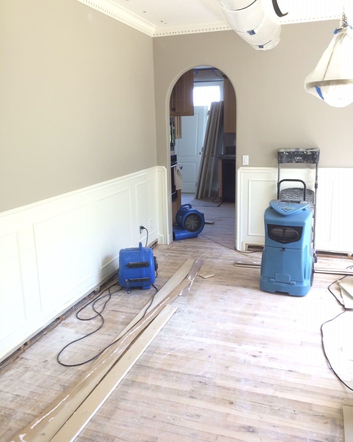 A blue commercial dehumidifier and blue centrifugal fans drying out a residence at 31213 NE 69th St Camas, WA 98607