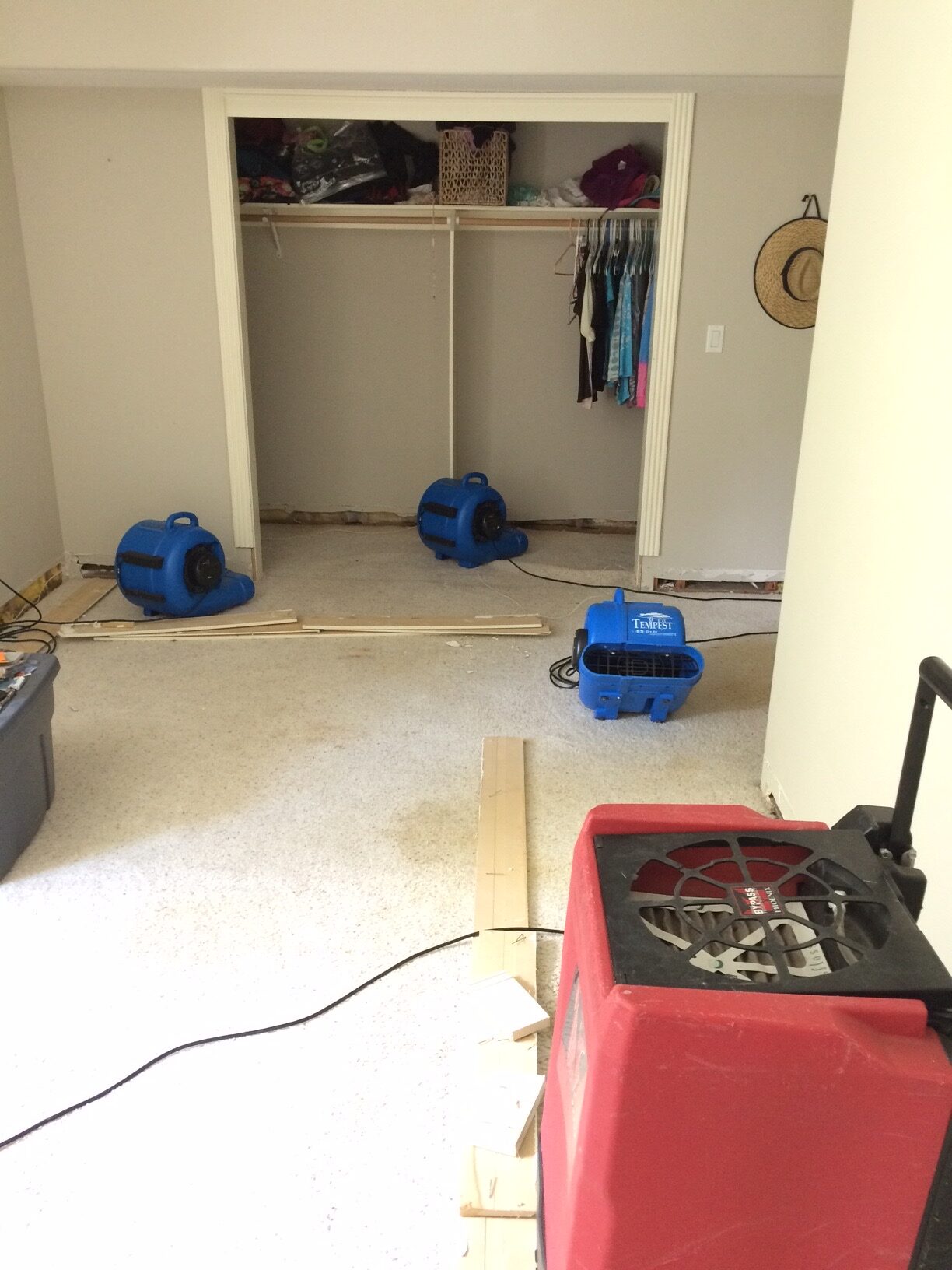 Image of a red commercial dehumidifier and 3 blue centrifugal fans running at a water damage restoration 31213 NE 69th St Camas, WA 98607