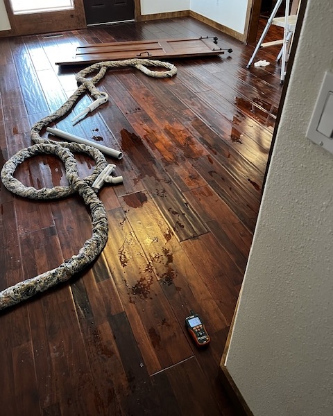 Water all over hardwood floors at a water damage restoration project in Ridgefield WA