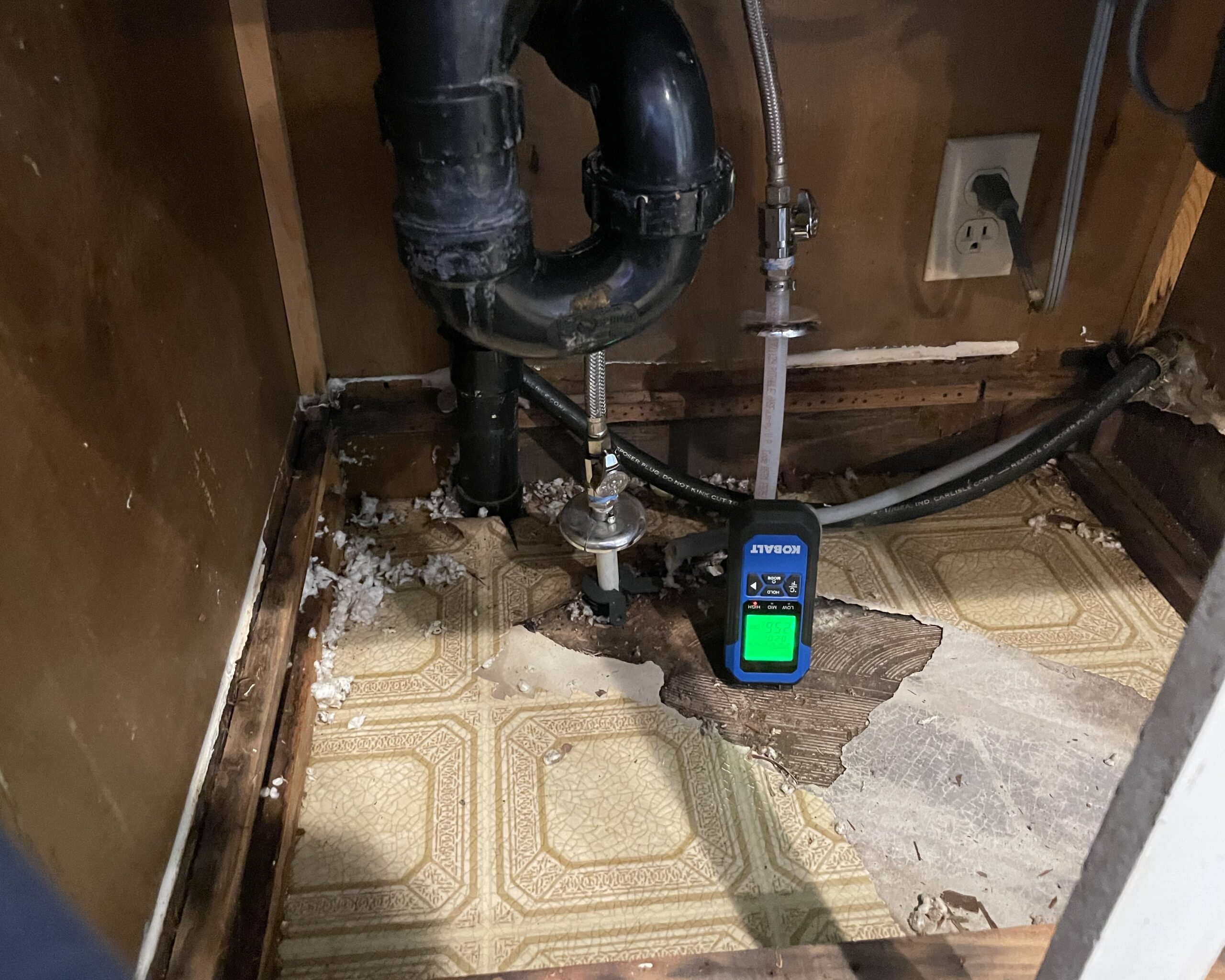 A penetrating moisture meter identifying where the source of the failed water supply line was located, under the kitchen sink at 28406 NE 172ND AVE Battle Ground, WA 98604