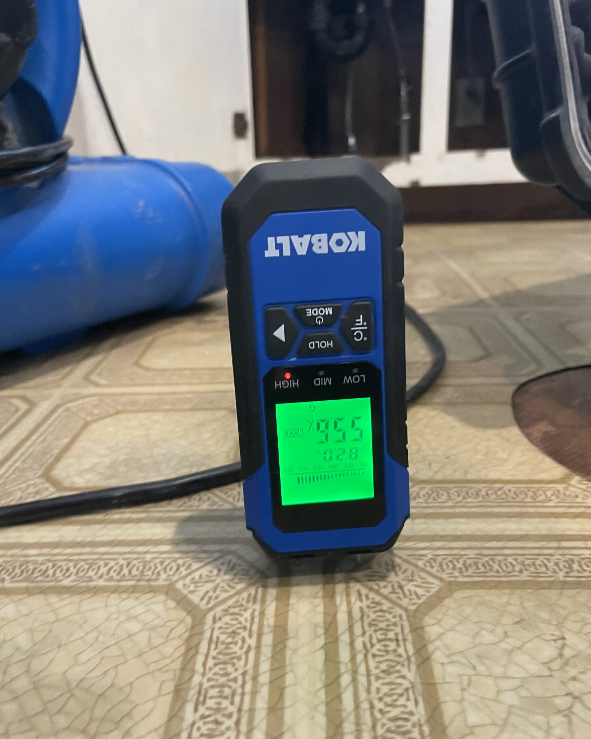 Blue penetrating moisture meter reading high moisture though a vinyl floor at a water damage at 28406 NE 172ND AVE Battle Ground, WA 98604