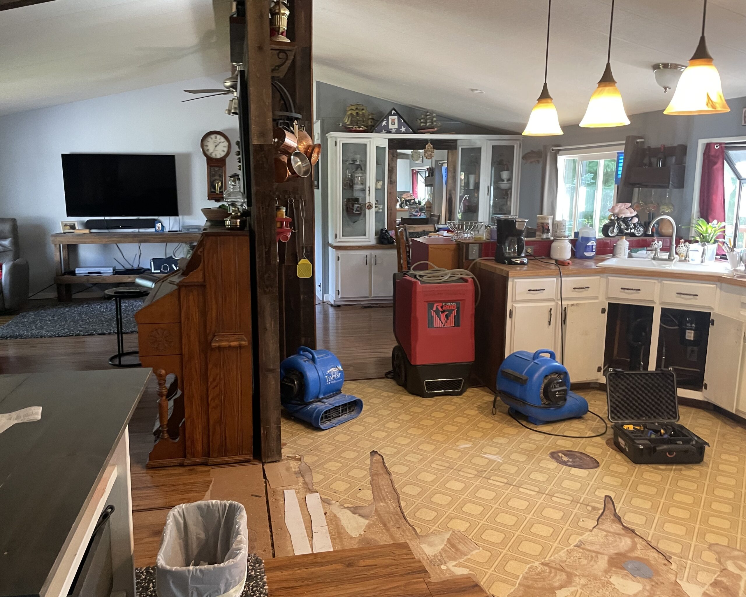 Living room at 28406 NE 172ND AVE Battle Ground, WA 98604 with the laminate floor removed exposing areas affected by water damage.