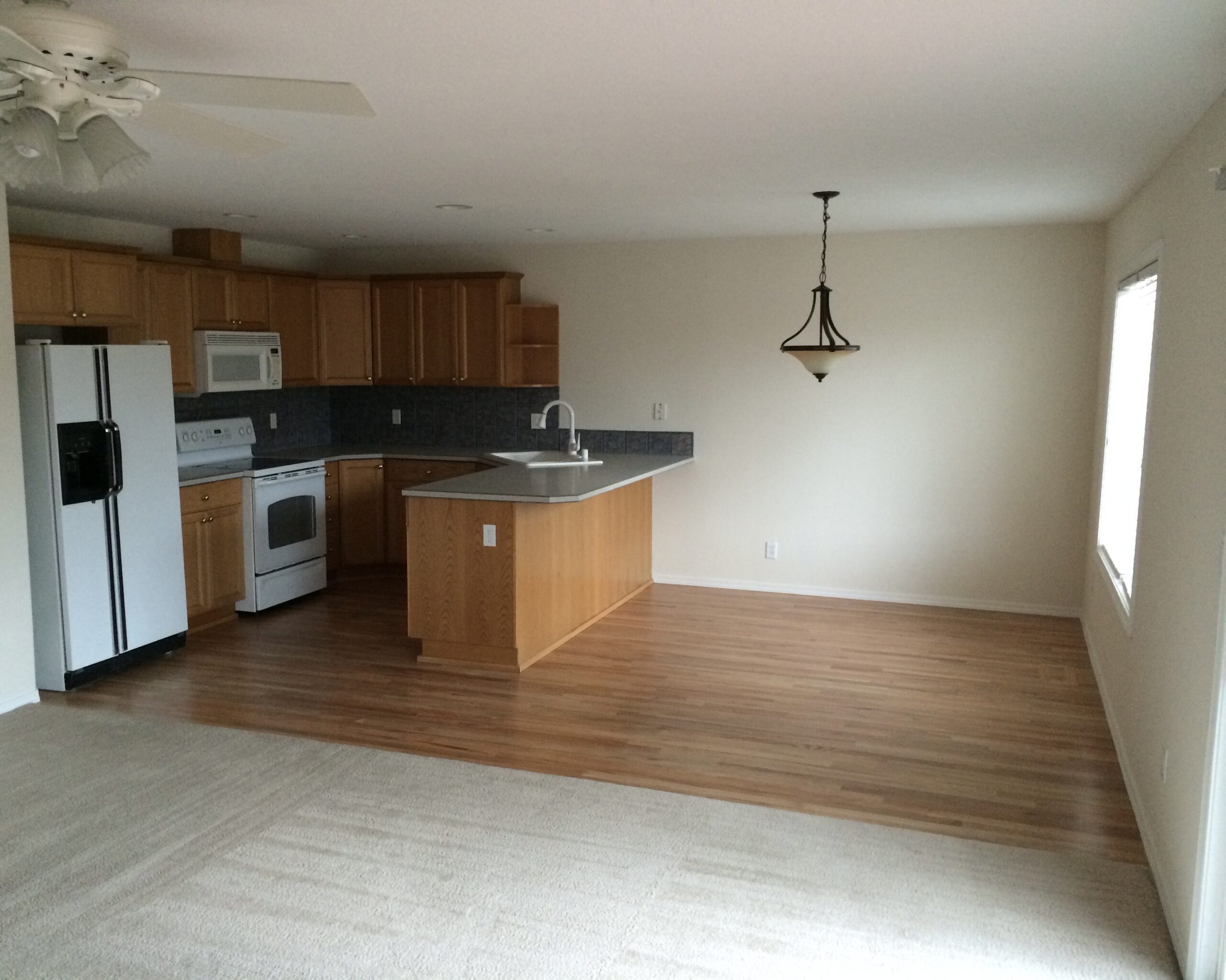 Image of a Salmon Creek WA kitchen and dining room after it had been restored with new walls, flooring, and carpet.