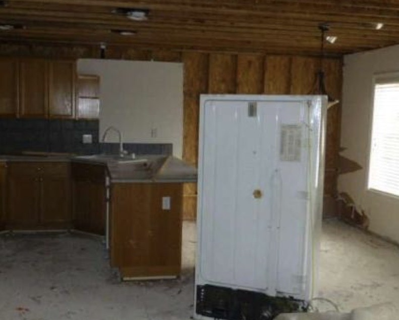 Image of a kitchen with the drywall removed from the ceiling and walls after a frozen pipe burst and cause a water damage throughout the Salmon Creek Washington Home